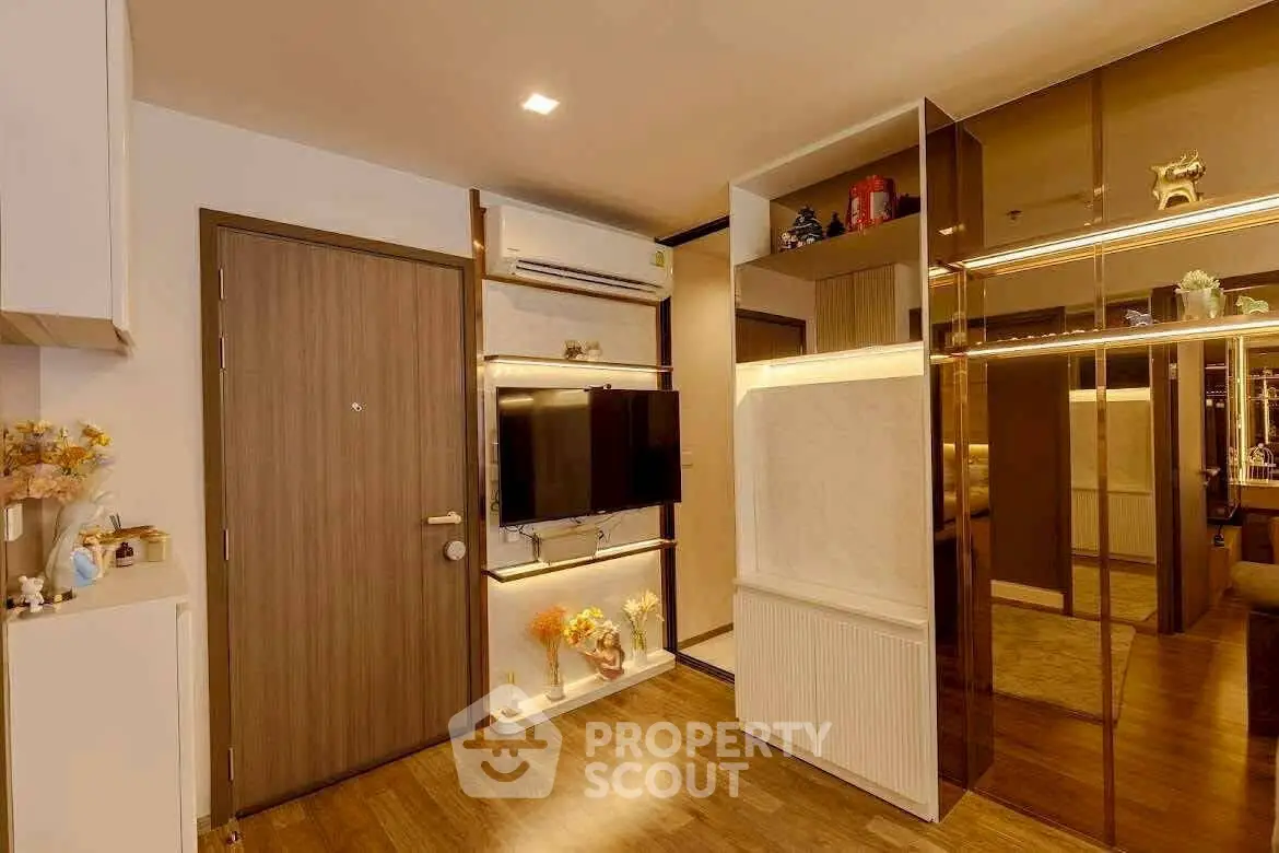 Modern living room with stylish decor and wall-mounted TV in a cozy apartment.