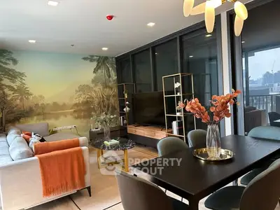 Modern living room with stylish decor, large sofa, and scenic wall mural, perfect for relaxation and entertainment.