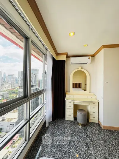 Spacious bedroom with city view and elegant vanity in high-rise apartment