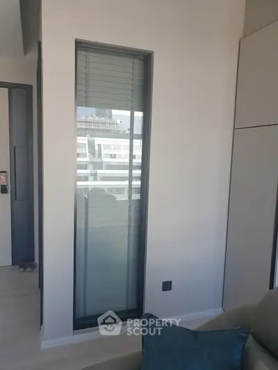 Modern apartment interior with large window and sleek design