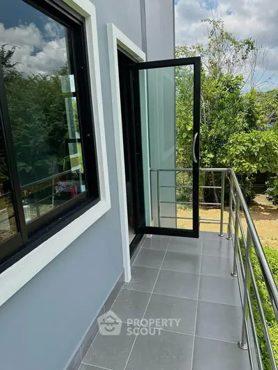 Modern balcony with sleek railing and garden view