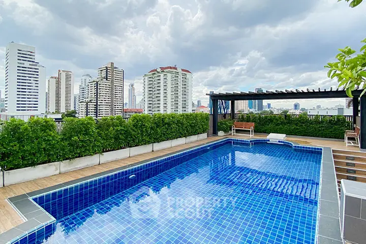 Stunning rooftop pool with city skyline view, perfect for relaxation and entertainment.