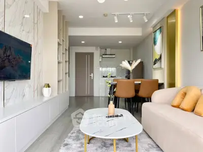 Modern living room with open layout, stylish decor, and cozy seating area.