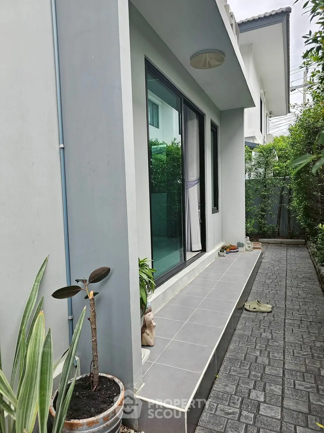 Charming modern home exterior with lush greenery and sleek design