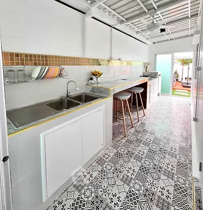 Chic kitchen with open layout and stylish tile flooring, perfect for modern living.