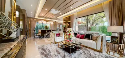 Luxurious living room with elegant decor and large windows offering garden views.