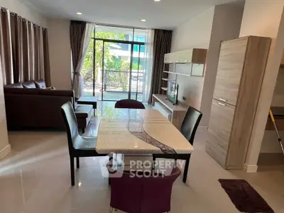 Spacious modern living room with elegant dining area and large windows for natural light.