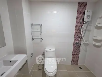 Modern bathroom with sleek white tiles and shower heater