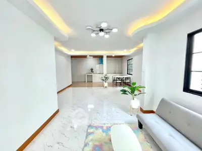 Spacious modern living room with open kitchen and stylish lighting