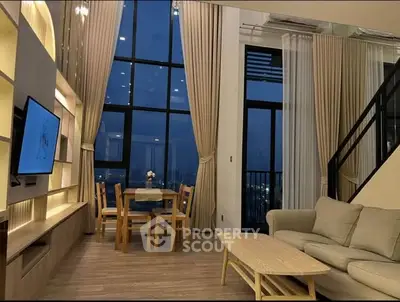 Luxurious high-ceiling living room with stunning night view and elegant furnishings.
