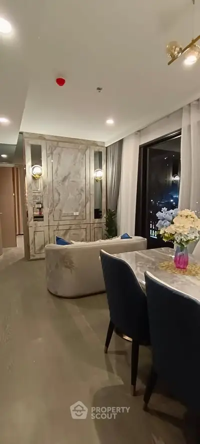 Luxurious modern living room with elegant decor and large windows offering stunning views.