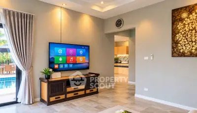 Modern living room with wall-mounted TV and pool view, featuring elegant decor and open kitchen access.