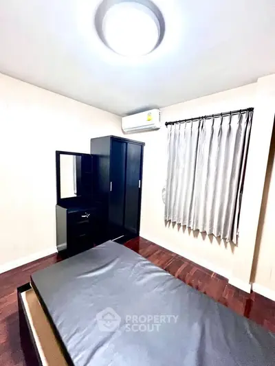 Cozy bedroom with modern furniture and air conditioning, perfect for comfortable living.