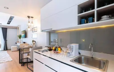 Modern open-layout kitchen with sleek white cabinets and cozy dining area