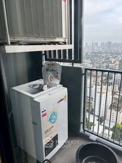 High-rise balcony with washing machine and city skyline view, perfect for urban living.