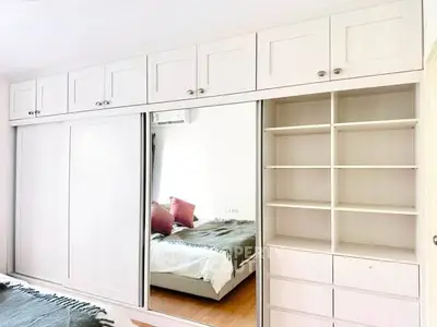 Spacious bedroom with built-in wardrobe and mirrored sliding doors