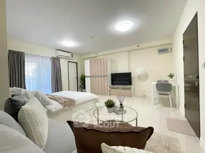 Modern studio apartment with cozy living area and stylish decor