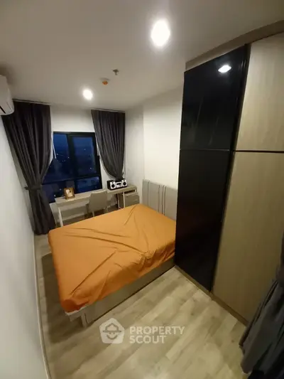 Cozy bedroom with modern decor and city view window