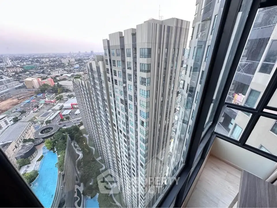 Stunning high-rise building view from a modern apartment window, showcasing urban skyline and luxurious amenities.