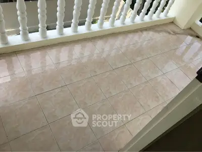 Charming tiled balcony with elegant railing, perfect for relaxation and enjoying outdoor views.
