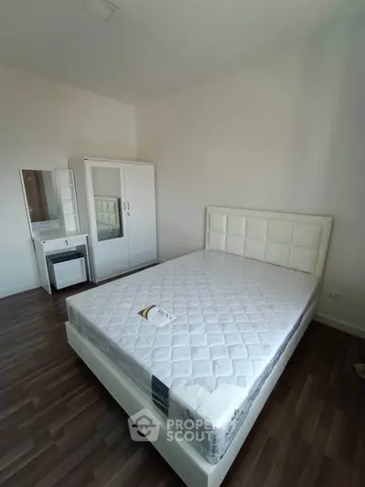 Modern bedroom with sleek furniture and hardwood flooring
