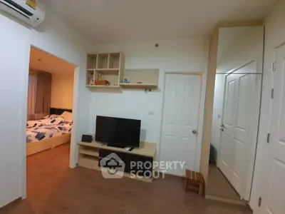 Cozy apartment living room with TV and bedroom view