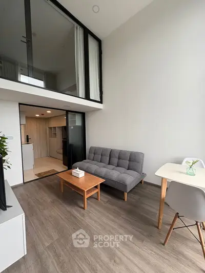 Modern living room with mezzanine and stylish furniture in a bright apartment