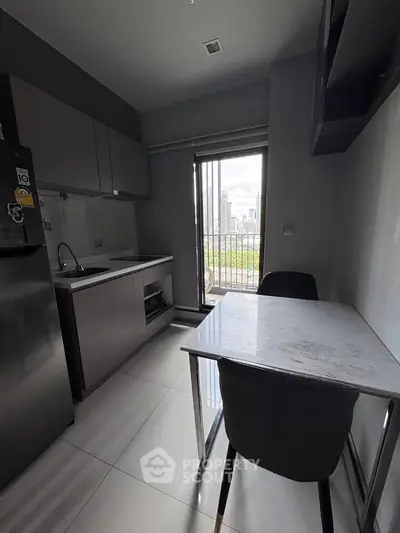Modern kitchen with sleek design and city view from balcony