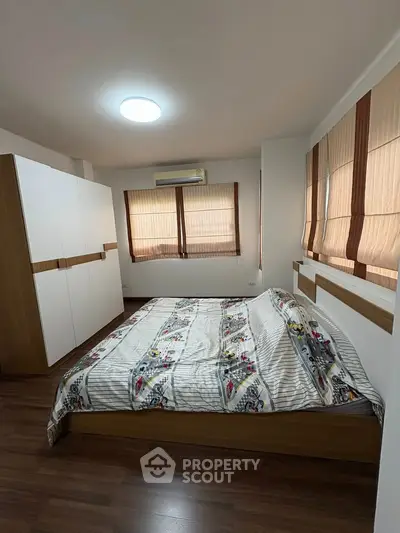 Spacious bedroom with modern decor and ample natural light