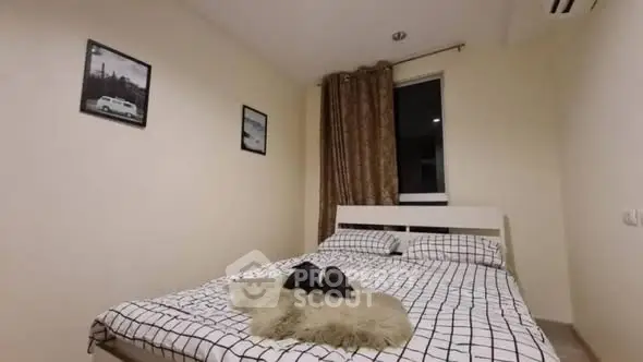 Cozy bedroom with modern decor and large window for natural light.