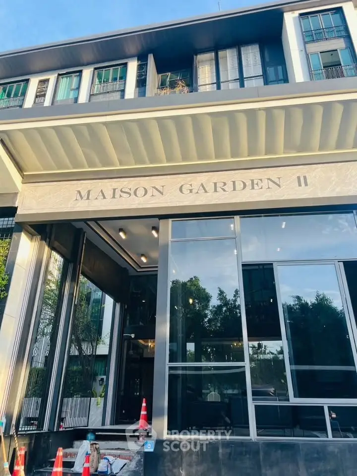Elegant modern building facade of Maison Garden II with glass entrance and stylish architecture.