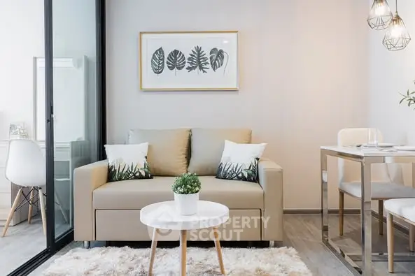 Stylish modern living room with cozy sofa and dining area