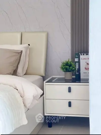 Elegant bedroom corner with modern nightstand and cozy bed setup