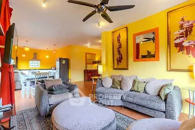 Vibrant living room with modern decor and open layout, featuring stylish furniture and bright yellow walls.