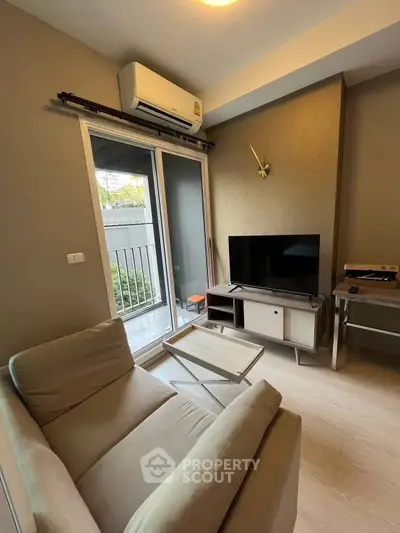 Cozy living room with modern decor and balcony access in a stylish apartment.