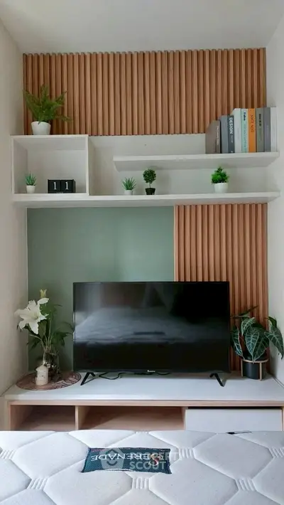 Modern living room with stylish TV setup and decorative shelves