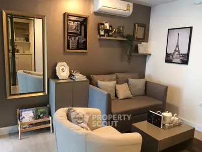 Cozy living room with modern decor, featuring a comfortable sofa, stylish armchair, and elegant wall art.
