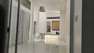 Spacious modern living room with high ceilings and elegant lighting