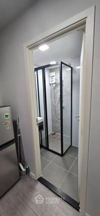 Compact bathroom with modern shower enclosure and sleek design.