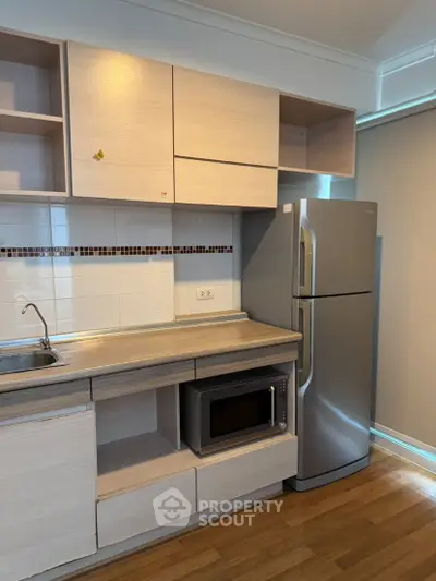 Modern kitchen with sleek cabinets and stainless steel fridge