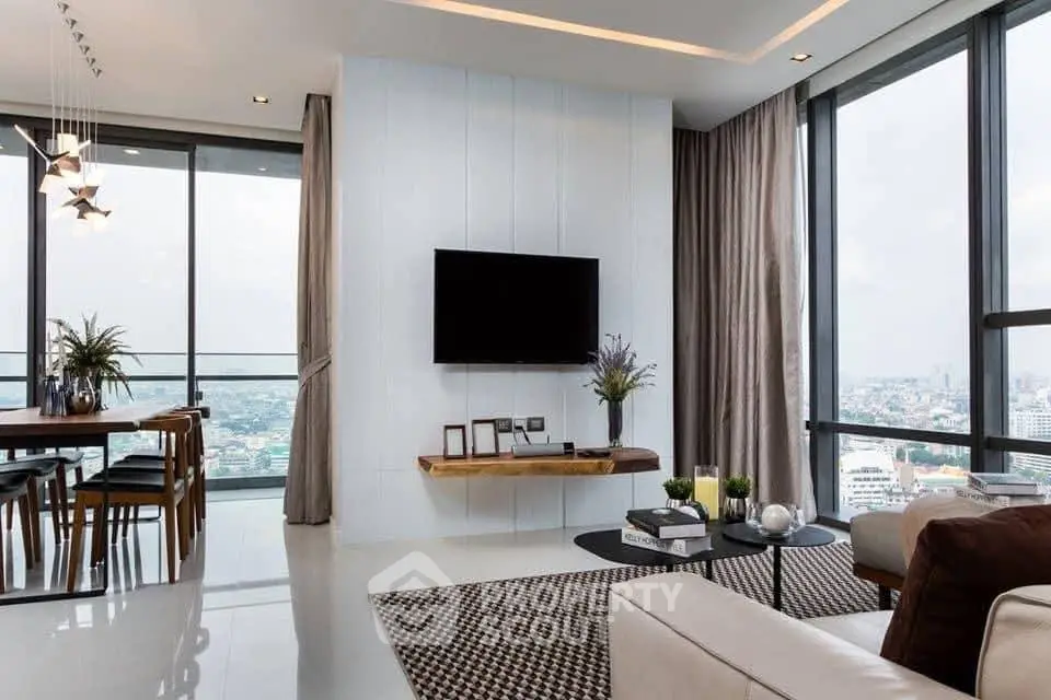 Luxurious modern living room with panoramic city view and elegant decor.