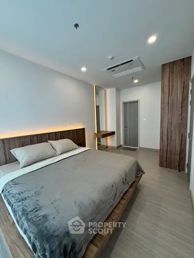 Modern bedroom with stylish wooden accents and cozy lighting