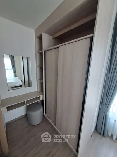 Modern bedroom with built-in wardrobe and vanity in a stylish apartment