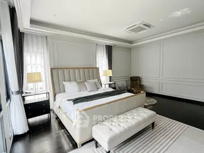Luxurious master bedroom with elegant decor and ample natural light
