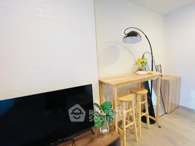 Modern living room with stylish bar stools and sleek TV setup