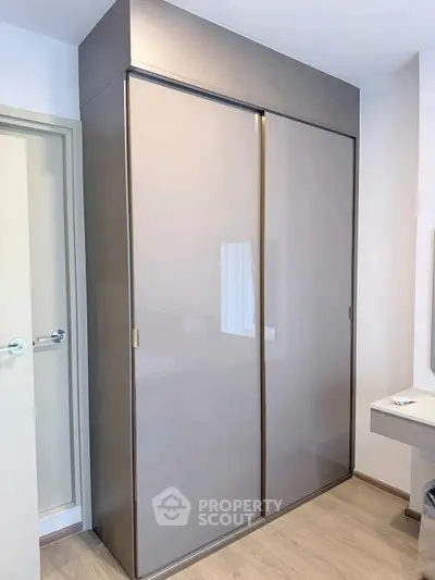 Modern bedroom with sleek sliding wardrobe and minimalist design