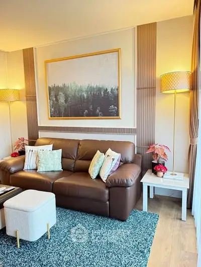 Stylish living room with leather sofa, modern decor, and ambient lighting.