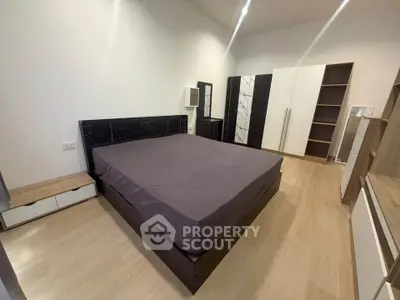 Spacious bedroom with modern furnishings and ample storage space