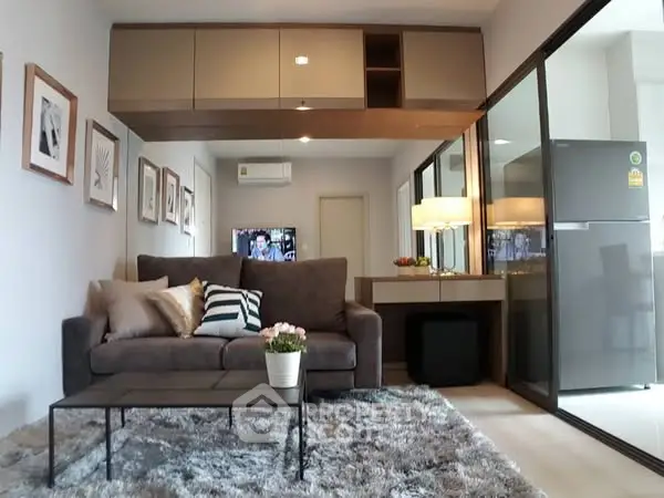 Modern living room with cozy sofa, stylish decor, and open kitchen layout in a contemporary apartment.