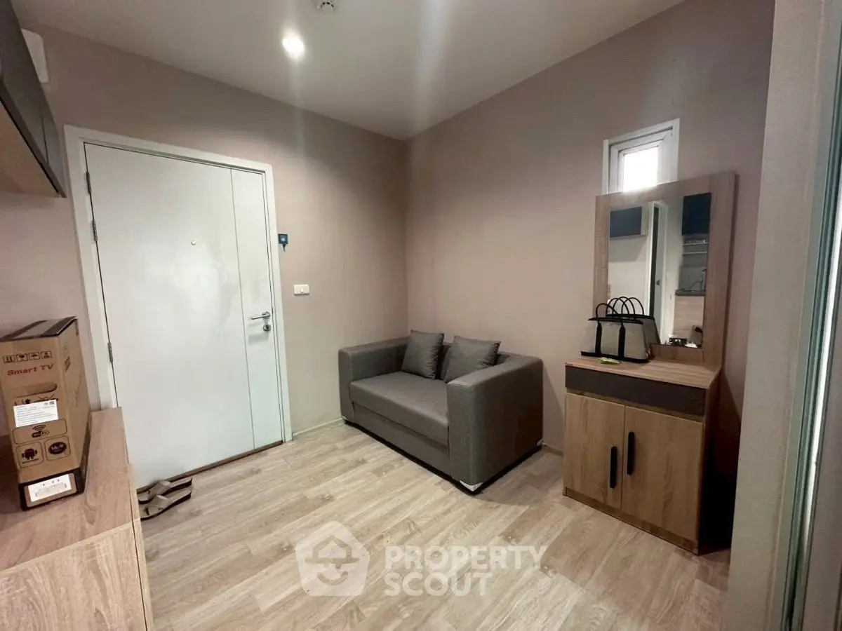 Cozy interior with modern sofa and stylish wooden cabinet in a compact living space.
